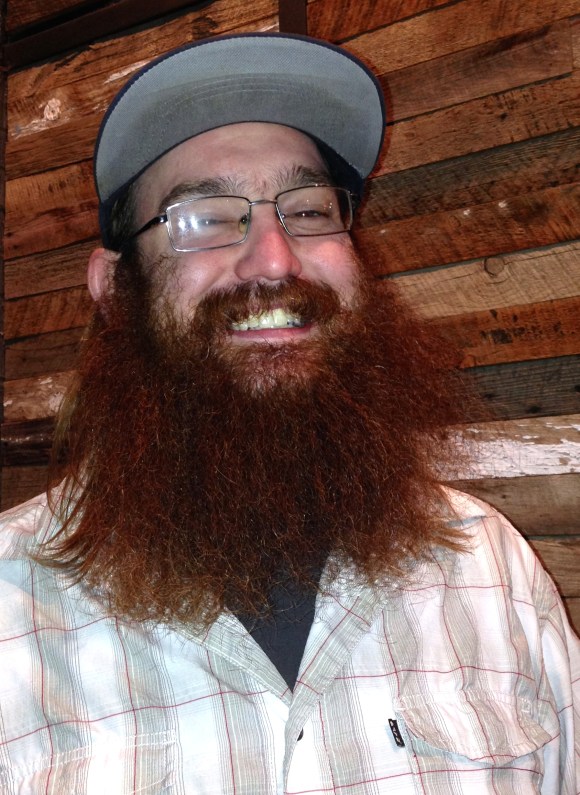 The ladies of Beards of Denver always feel fortunate when we are lucky enough to meet a new (to us) bearded Denver gentleman, and we always have a hunch when we visit one of our fair city’s wonderful breweries that Lady Bearded Luck is a bit more likely to smile upon us. Such was the case on a recent fall night in Denver, where we were happened upon Kyle and his fiery-gingerbeard as we were walking into Black Shirt Brewing in RiNo neighborhood.  Kyle, who is originally from Mississippi, lives in North City Park with his lovely sweetheart Erin and their dog Belle.   His glorious beard originates from the fact that he’s not very good at shaving, and he noted “Everybody loves it.” And how could you not love such a beard with that captivating fiery hue?  Kyle’s redbeard is even more fitting when we found out he works at Fire on the Mountain in Highlands, our favorite wings spot in the city (and a mecca to find many impressive beards to admire).  In addition to Kyle’s dedication to his beard, he has major allegiance to D-Town, proudly stating, “What other cities compare to Denver?? San Fran is cool, but it’s NOT Denver.” We couldn’t agree more Kyle.  You and that fantastic beard of yours best never leave! 
