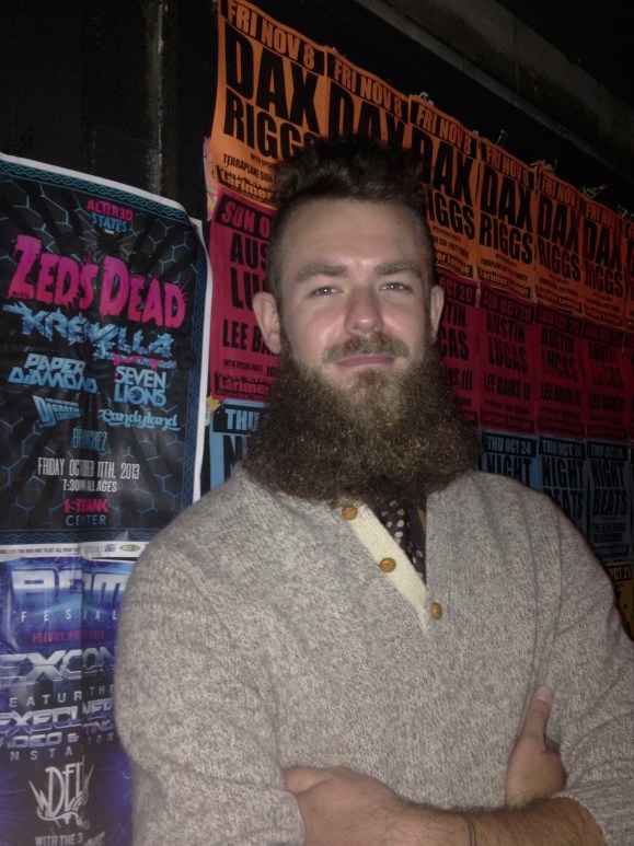  On occasion, the stars align for the ladies of Beards of Denver.  When we think we’re simply heading out on the town for an always-innocent night of sippin’ whiskey and dancin’ to the folk-Americana-bluegrass-accordion-laced music we fancy, wouldn’t you know, a fabulous beard enters our orbit. Such was the case on a recent Friday night at Larimer Lounge in Denver, when our already wonderful night of listening to the amazing tunes of Hurray for the Riff Raff and Spirit Family Reunion was topped off by meeting Joe from Denver and admiring his amazing beard.  Believe it or not, ladies and gentlebeards, this is Joe’s first foray into serious beard growth.  He’s been growing his beard since February, and shared with us that lots of guys “Think they are not beard guys because it grows in patchy” but was adamant they need to stay the course and get past those uncomfortable stages until they reach full beard glory. We, of course, couldn’t agree more.  Joe, who often used to shave his head, altered his hair cut to complement his beard. Such good choices!  Joe shampoos his beard every few days, and came about using a beard cream in a rather serendipitous fashion.  Walking into the Dive Inn bar on South Broadway one night, he encountered a bar back there who makes a beard cream called Don’s Beard Cream, which accounts for his beard’s soft texture (turns out you can buy this at Indie 6).  Yet another example of wonderful Denver Beard-brotherhood. Originally from Cedar Rapids, Iowa, this good Midwestern boy has called our fair city of Denver home the past eight years.  When not grooming his beard, he plays guitar and generally philosophizes.  Believe it or not ladies, Joe’s a free agent, which we’re sure won’t last for long with a beard like his.  He plans to put in at least a full year of beard growth, declaring “I feel like I’ve come so far and I need to take it to the limit.  Why do anything if you’re not going to go all the way?” Take it all the way, Joe! We can’t wait to see how your beard progresses come February.